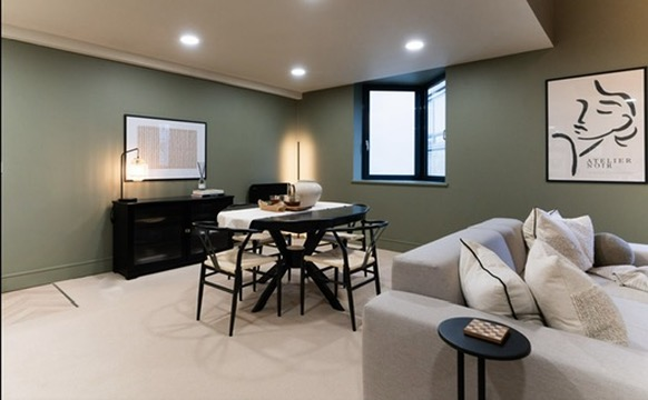 Green-walled dining and lounge space in a completed Oxfordshire property refurbishment
