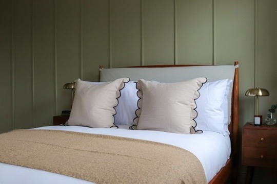 Bedroom furniture package installed in an Oxfordshire rental property, including bed frame, dressed bedding, bedside table and lighting